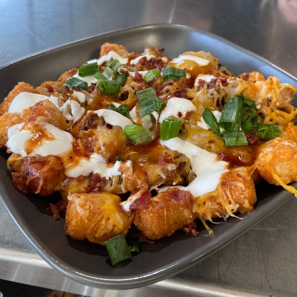 F325 BBQ's loaded tater tots with melted cheese, bacon bits, sour cream, and green onions.