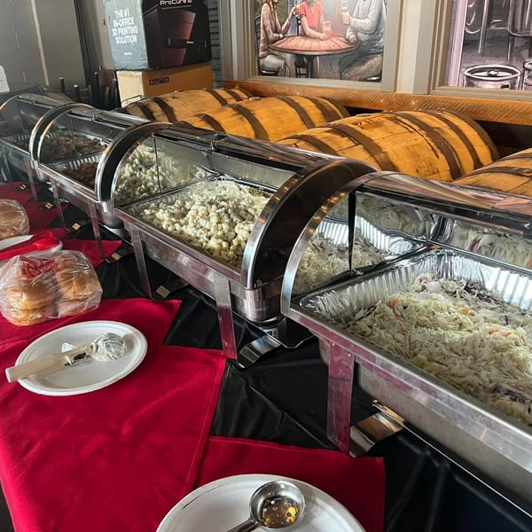 F325 BBQ buffet line with chafing dishes of macaroni salad, coleslaw, and pulled pork.