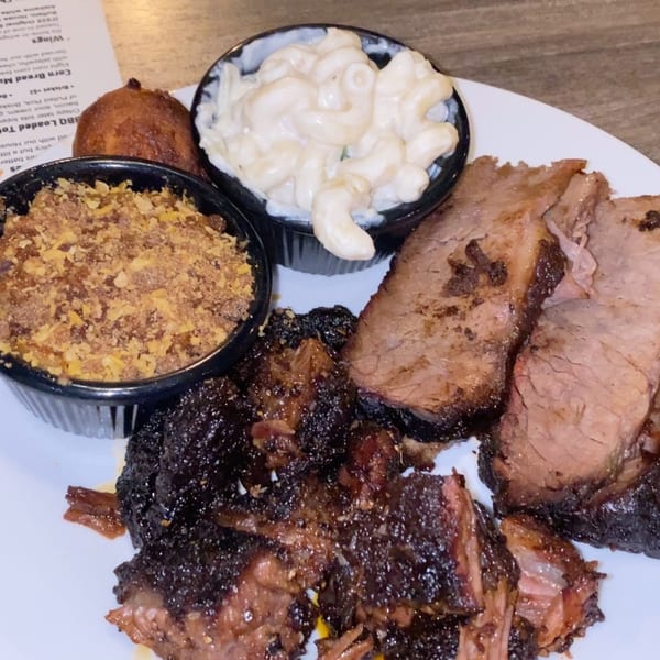 F325 BBQ platter with brisket, burnt ends, mac and cheese, corn pudding, and a hushpuppy.